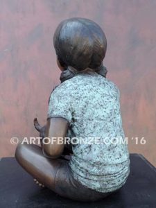Give me Attention bronze statue girl sitting down playing with puppy dog on her lap
