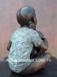 Give me Attention bronze statue girl sitting down playing with puppy dog on her lap