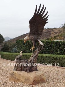 Dinner for Two statue of a life-size bald eagle feeding its baby eaglet in nest