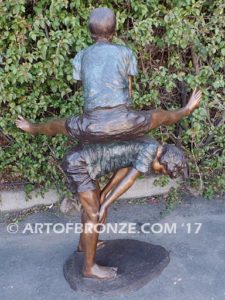 Leapfrog bronze sculpture of two kids playing leapfrog