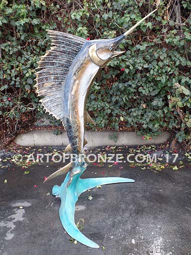 Heroic sculpture of bronze leaping sailfish that can spray water from bill into shopping center fountain