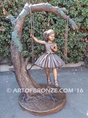 The Swing sculpture of pretty princess girl wearing dress on swing