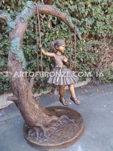 The Swing sculpture of pretty princess girl wearing dress on swing