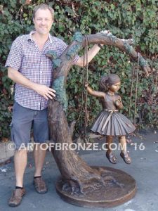The Swing sculpture of pretty princess girl wearing dress on swing