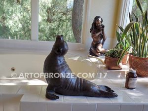 Sunbather bronze sea lion and seal mascot sculpture for zoo, university or school mascot