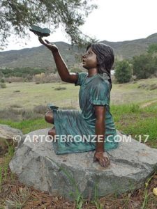 Wings of Joy bronze sculpture of sitting girl in dress with bronze butterflies