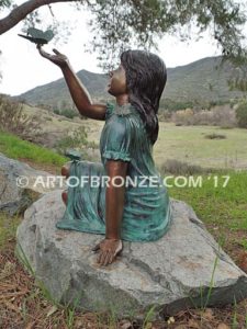 Wings of Joy bronze sculpture of sitting girl in dress with bronze butterflies