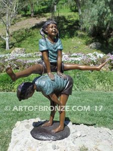 Leapfrog bronze sculpture of two kids playing leapfrog