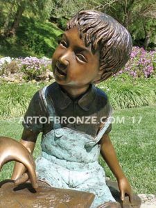 Favorite Teacher bronze sculpture of older girl reading book to younger boy
