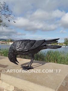 Raven bronze sculpture of ravens playing bench at lake