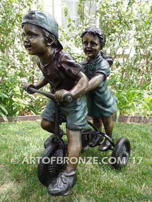 Endless Summer bronze sculpture of kids riding tricycle