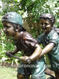 Endless Summer bronze sculpture of kids riding tricycle