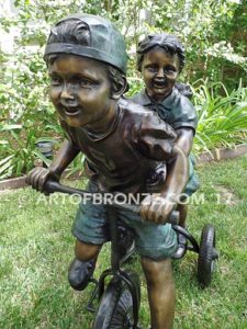 Endless Summer bronze sculpture of kids riding tricycle