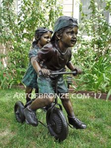 Endless Summer bronze sculpture of kids riding tricycle