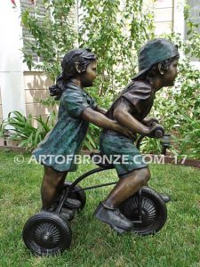 Endless Summer bronze sculpture of kids riding tricycle