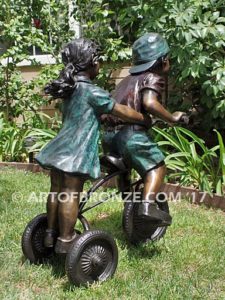Endless Summer bronze sculpture of kids riding tricycle