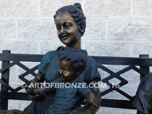 Special Day Together bronze sculpture of mother sitting on bench playing with her daughter, baby and soccer son