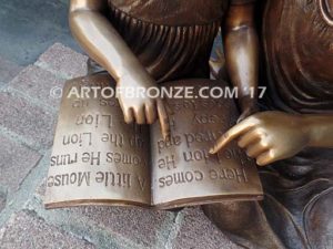 Together Forever bronze sculpture of older girl tutoring younger girl with book