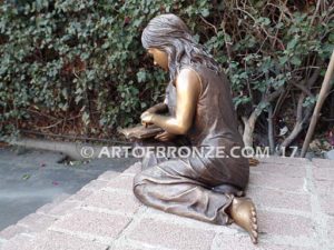 Together Forever bronze sculpture of older girl tutoring younger girl with book