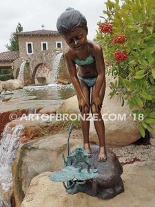 Pond Fun bronze sculpture of young girl in bathing suit playing with bullfrog