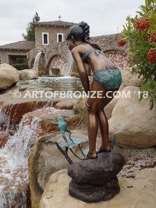 Pond Fun bronze sculpture of young girl in bathing suit playing with bullfrog