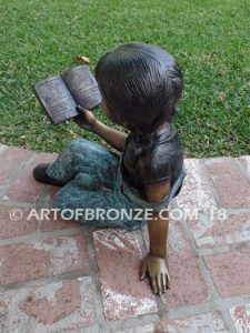 Book Smart back view A bronze sculpture of young sitting girl holding book