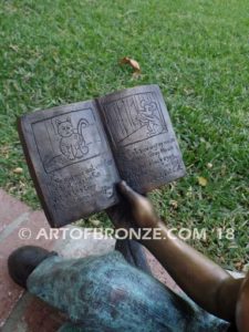 Book Smart closeup B bronze sculpture of young sitting girl holding book