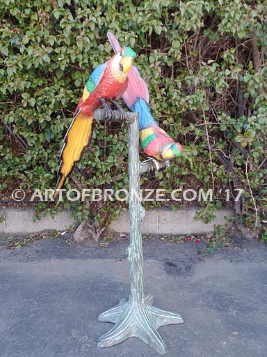 Double Talk statue of two macaws on a branch together