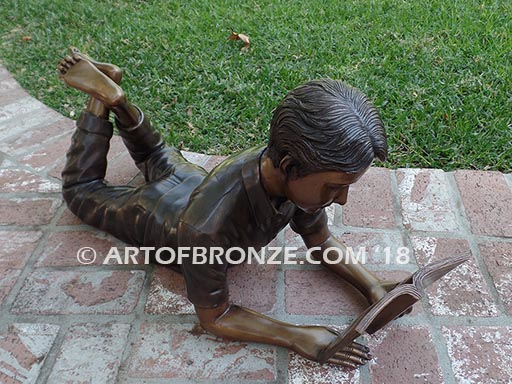 Best in His Class Sm bronze statue of boy lying down reading book