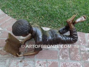 Best in His Class SV bronze sculpture of young boy reading his favorite novel