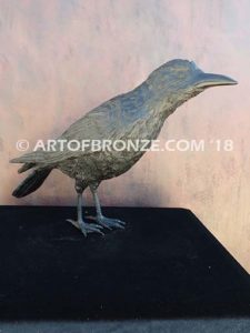 Raven bronze sculpture of raven looking straight ahead
