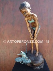 Pond Fun bronze sculpture of young girl in bathing suit playing with bullfrog