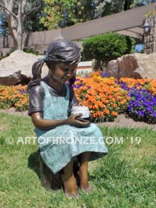 Birthday Wishes side view B bronze statue of girl with birthday cake
