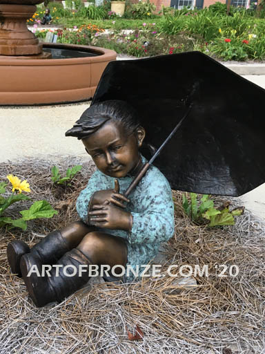 Summer Breeze bronze garden sculpture of cute young girl in the sun with umbrella