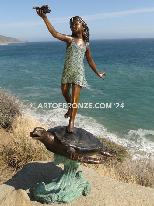 A Treasured Day Bronze statue of whimsical girl on sea turtle playing with conch shell