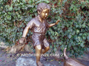 Adventurous Pals Bronze monumental sculpture for garden or yard of boy and dog crossing bronze log