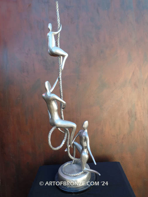 Balanced three abstract human sculptural bronze artworks