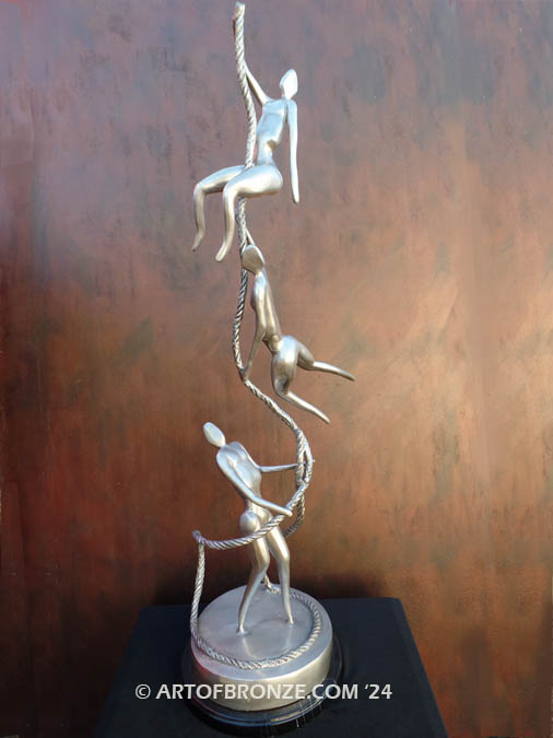 Balanced three abstract human sculptural bronze artworks