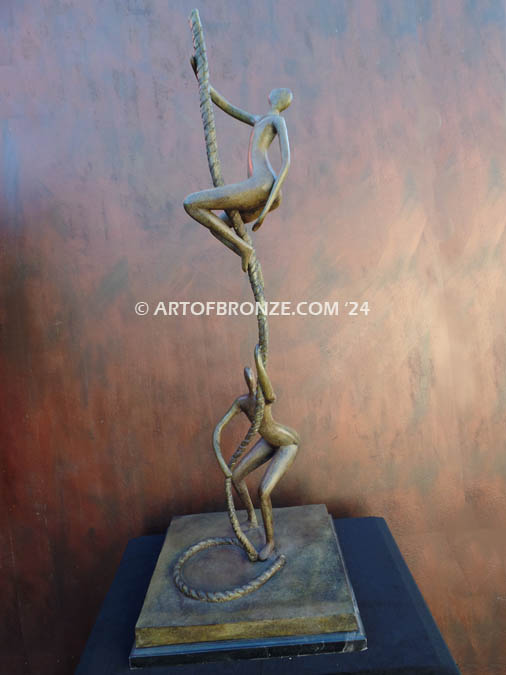 Balanced two abstract human sculptural bronze artworks