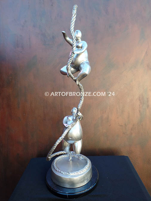 Balanced two abstract human sculptural bronze artworks