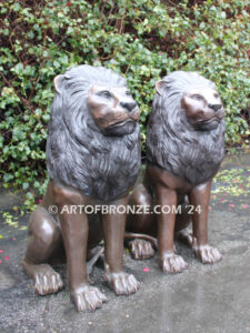 Beauty & Strength high quality cast bronze African lion pair sitting next to each other