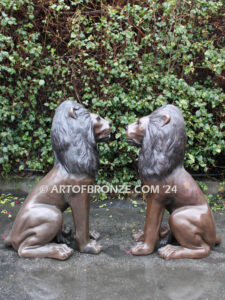 Beauty & Strength high quality cast bronze African lion pair sitting next to each other