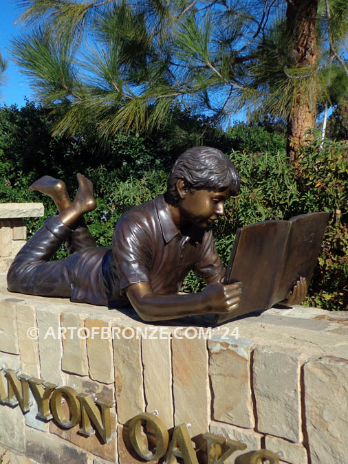 Best in His Class bronze statue of young boy reading his favorite novel