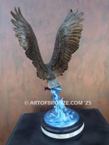 Bronze statue of flying eagle with captured salmon on custom marble base