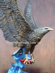 Bronze statue of flying eagle with captured salmon on custom marble base