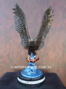 Bronze statue of flying eagle with captured salmon on custom marble base