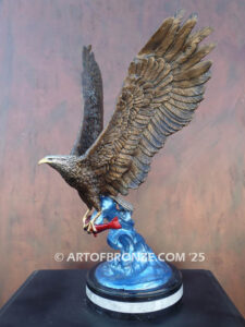 Bronze statue of flying eagle with captured salmon on custom marble base