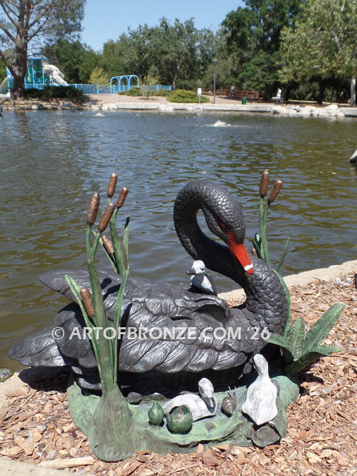 Black Swan outdoor life-size bronze sculpture of swan and playing cygnets