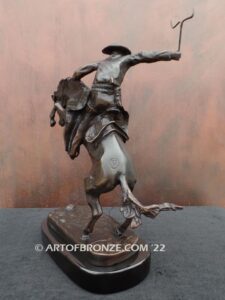 The Bronco Buster bronze sculpture after Frederic Remington featuring cowboy on horse