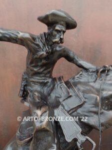 The Bronco Buster bronze sculpture after Frederic Remington featuring cowboy on horse